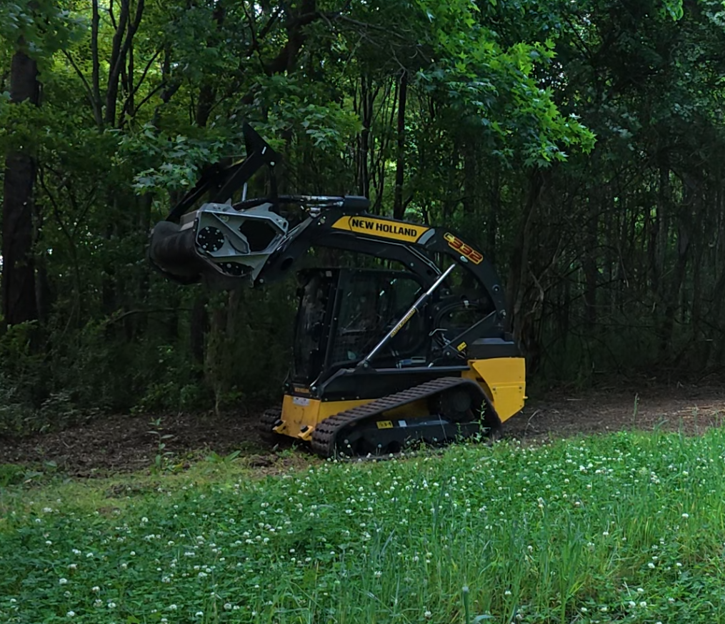New Holland C332 with FAE mulcher attachment for forestry mulching in Eastern NC